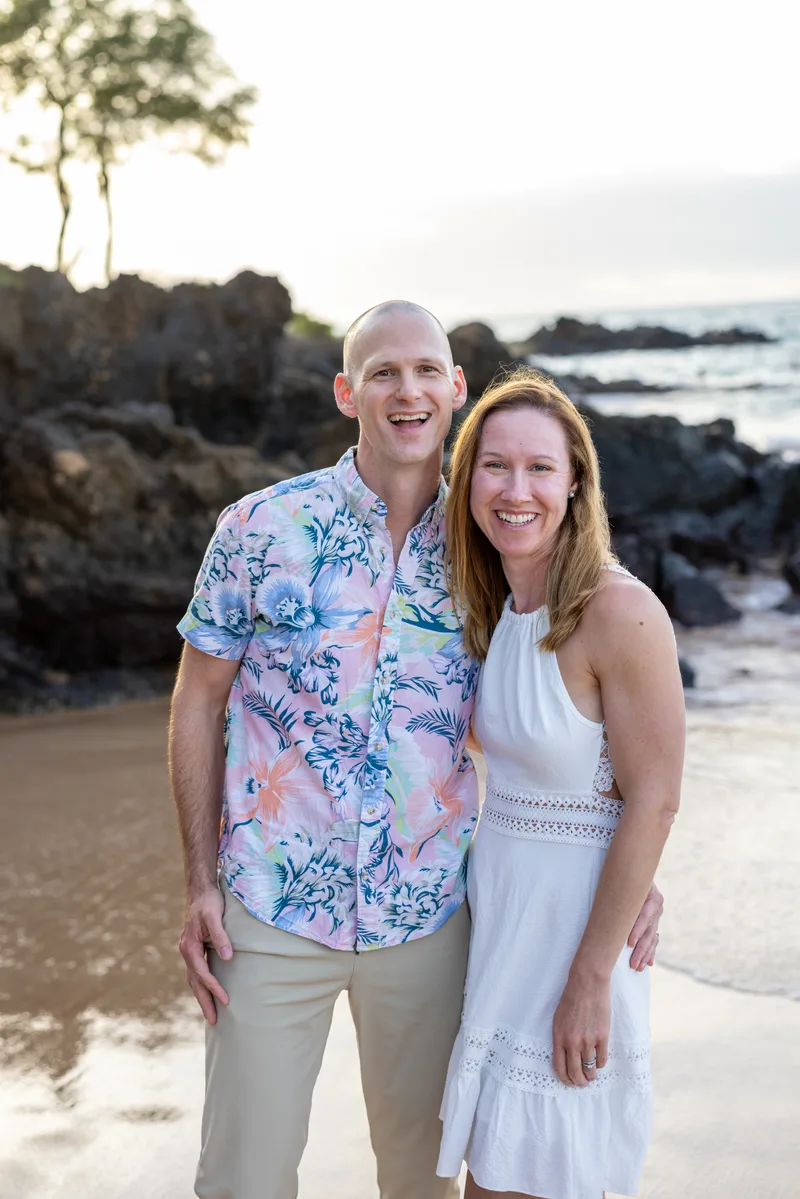 Tim and his wife on the beach at sunset