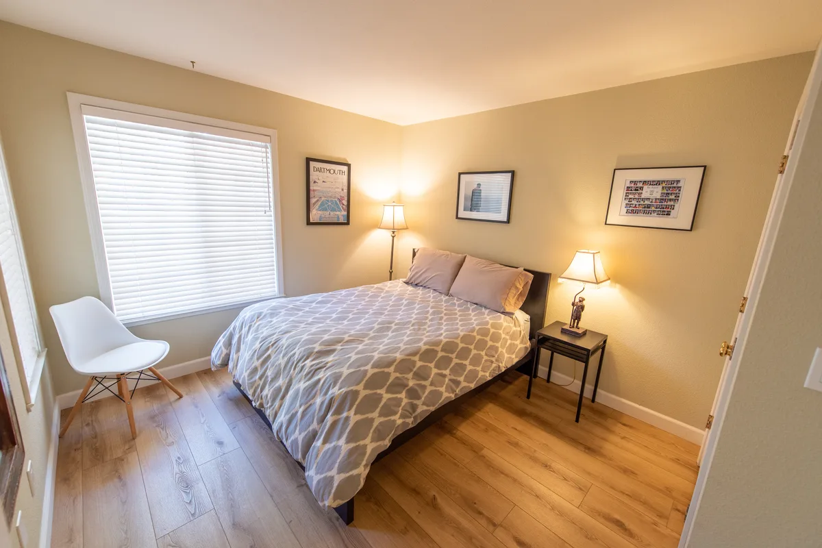 Second bedroom with a queen bed and bright window