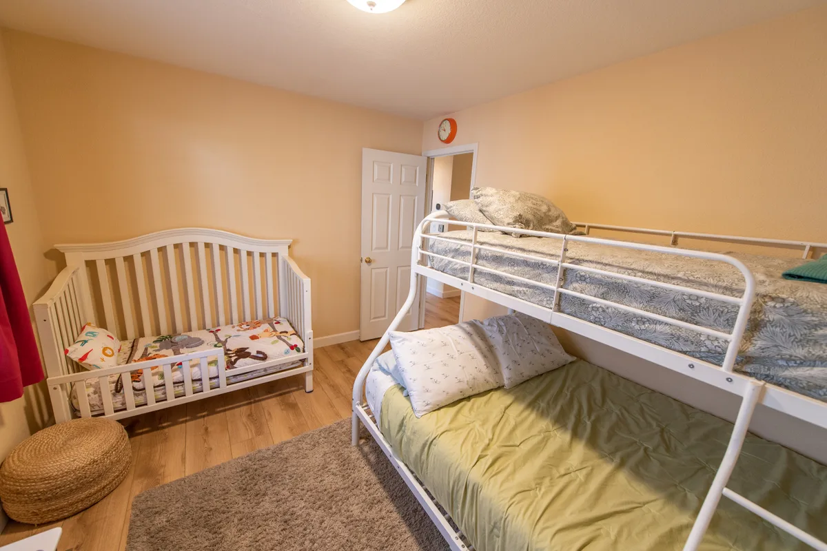 Kids' room with a bunk bed and a crib
